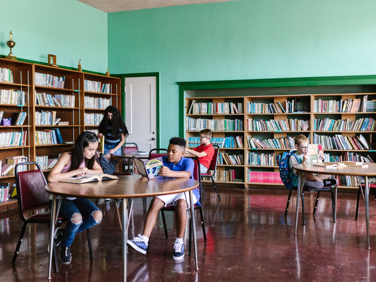 Children reading books together in the school library